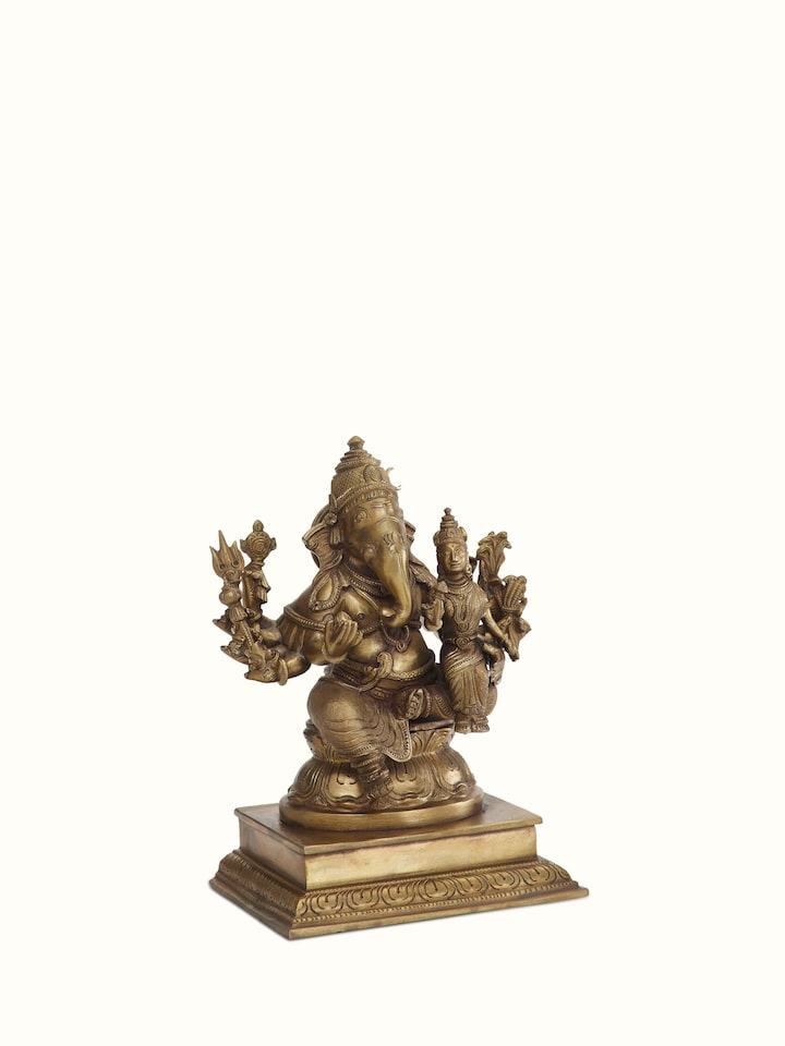Angled view of Lord Ganesha bronze casting idol emphasizing the rich bronze texture and ornate details.