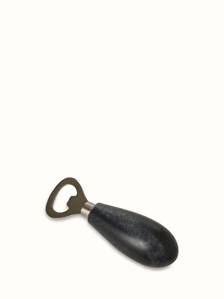 Side view of the marble and stainless steel bottle cap opener showing its elegant finish.