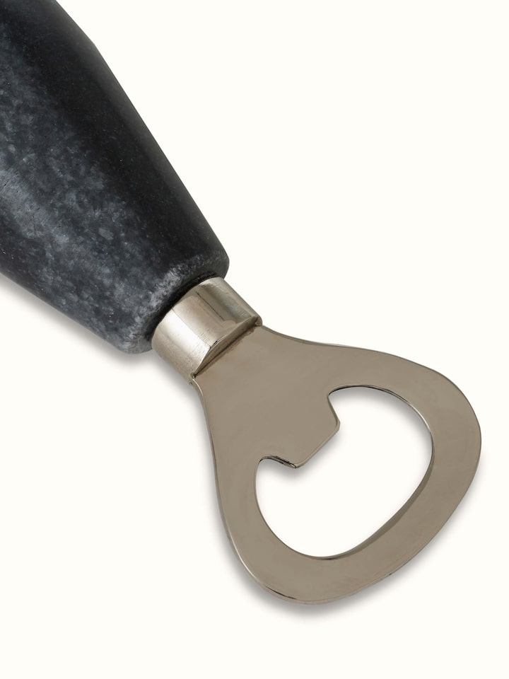 Full view of the marble and stainless steel bottle cap opener in black demonstrating its stylish look.