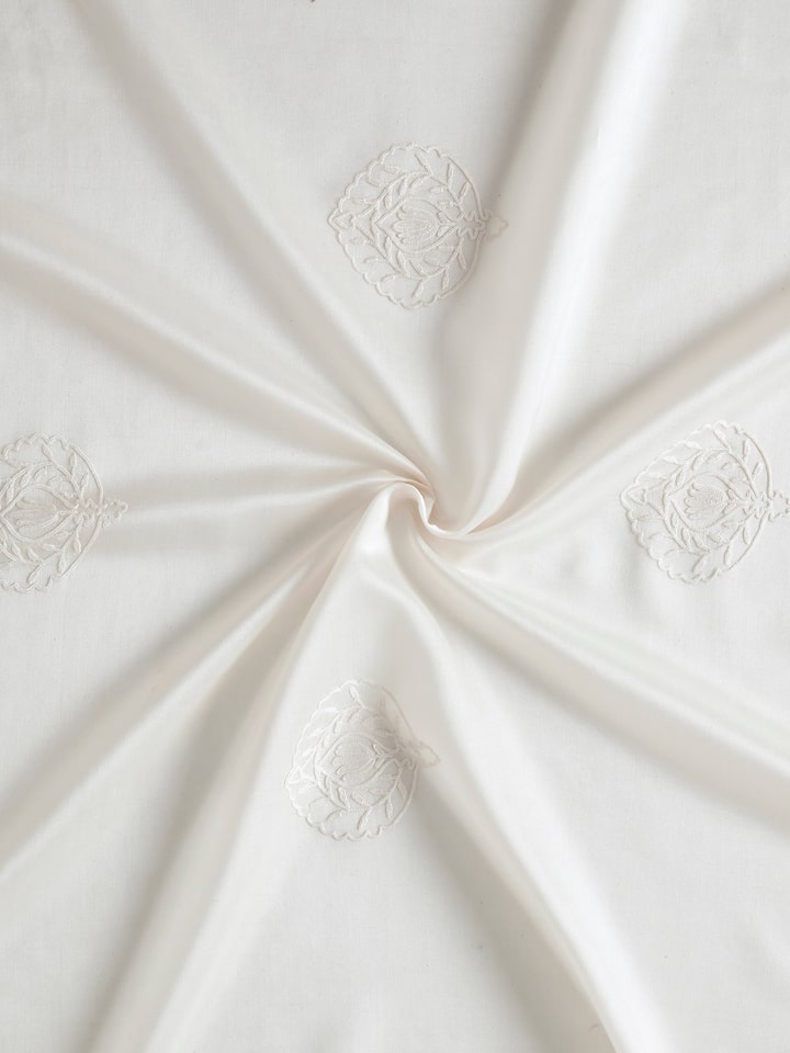 Detailed view of Razza ivory buti cotton silk crewel hand embroidered sheer curtain (9 ft) showing the fabric’s texture and embroidery work.