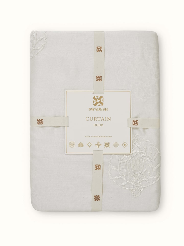 A side angle of the Razza Sheer Curtain showing the flowy drape, handloom craftsmanship, and light filtering effect of the cotton silk material.