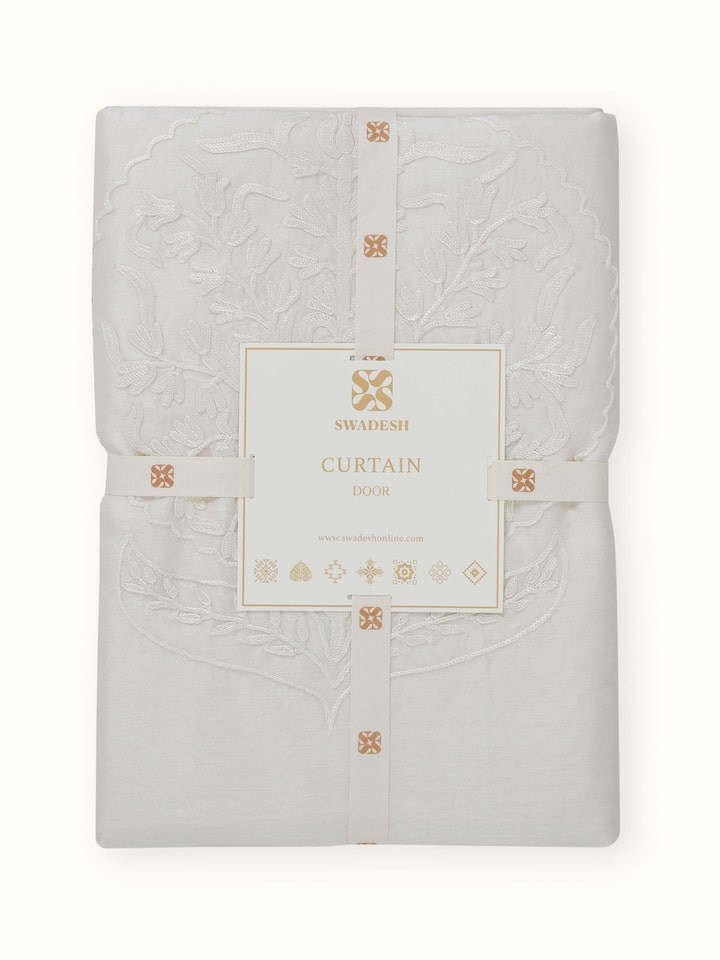 Angled view of Razza Cotton Silk Sheer Curtain, emphasizing the hand-embroidered floral motifs.