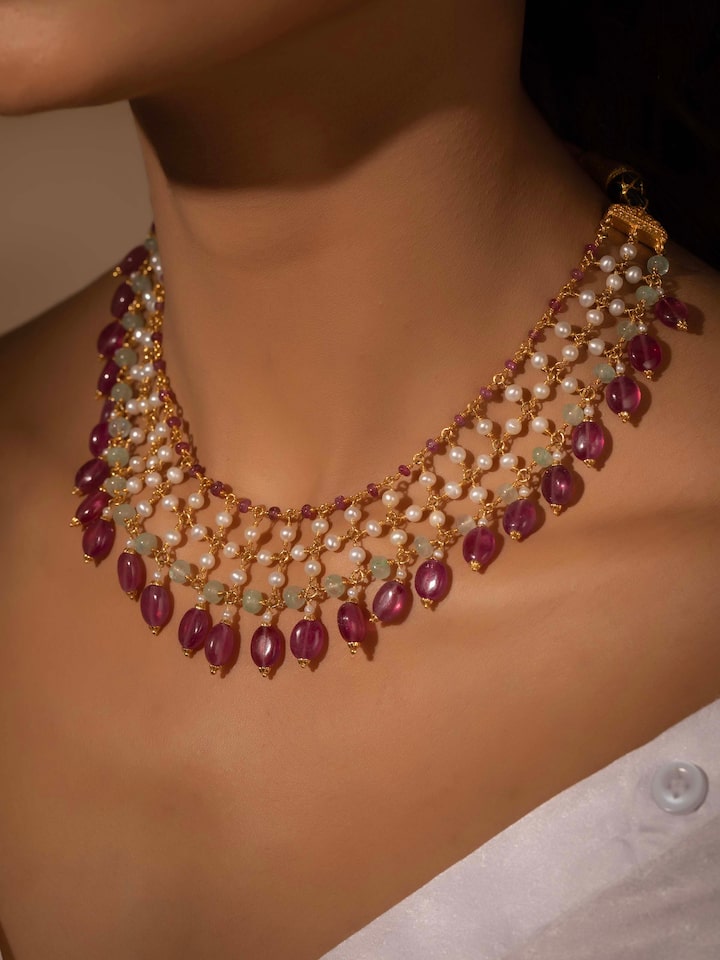 Styled detail view of Gemstone Strings Silver Collar Necklace worn on the finger, shown in another styled shot