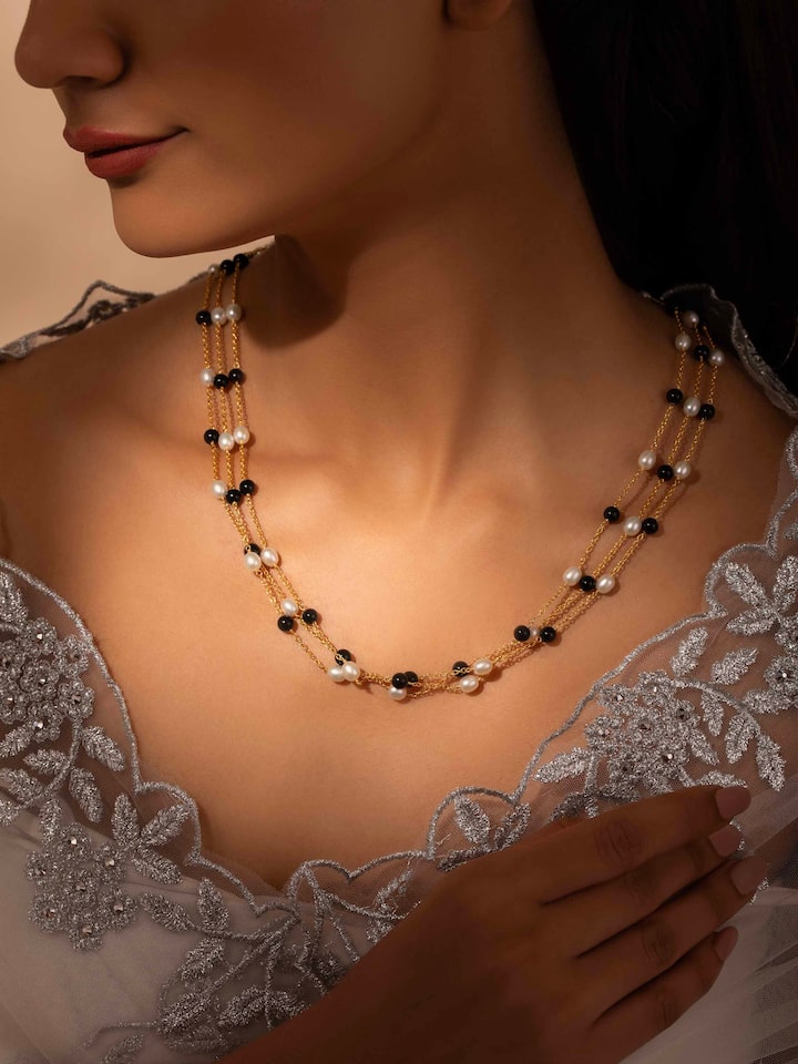 Styled detail view of Gemstone Strings Silver Long Necklace worn on the finger, shown in an alternate styled shot