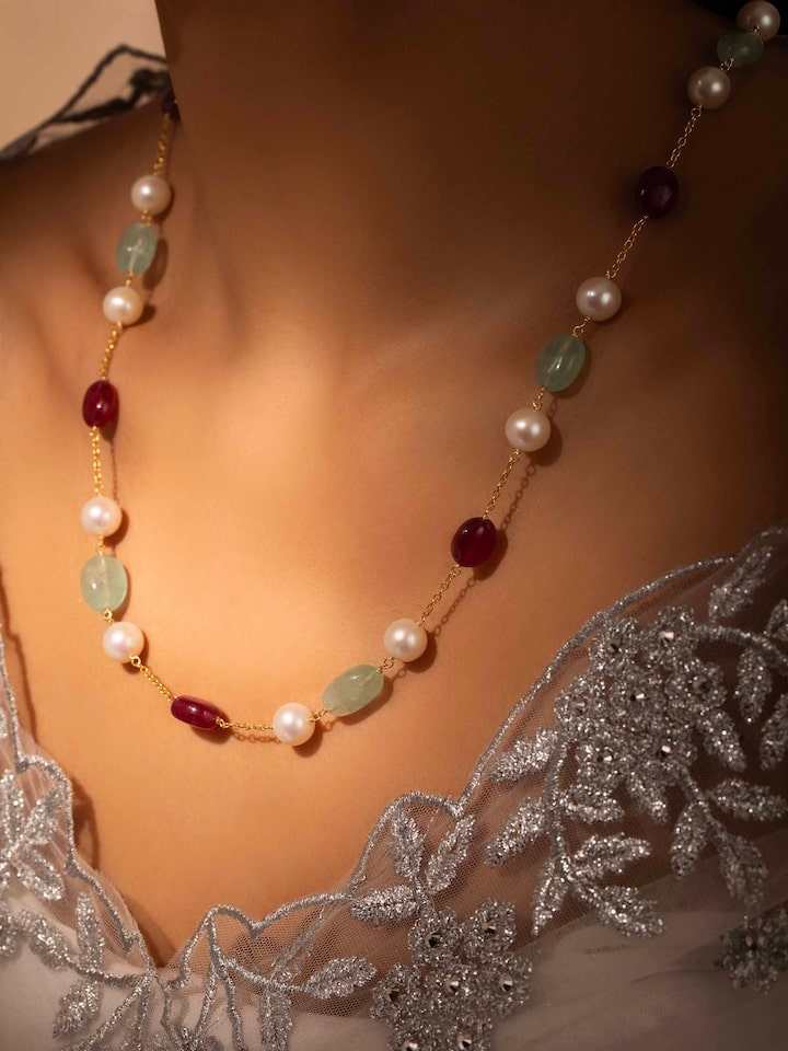 Styled detail view of Gemstone Strings Silver Long Necklace worn on the finger, shown in another styled shot