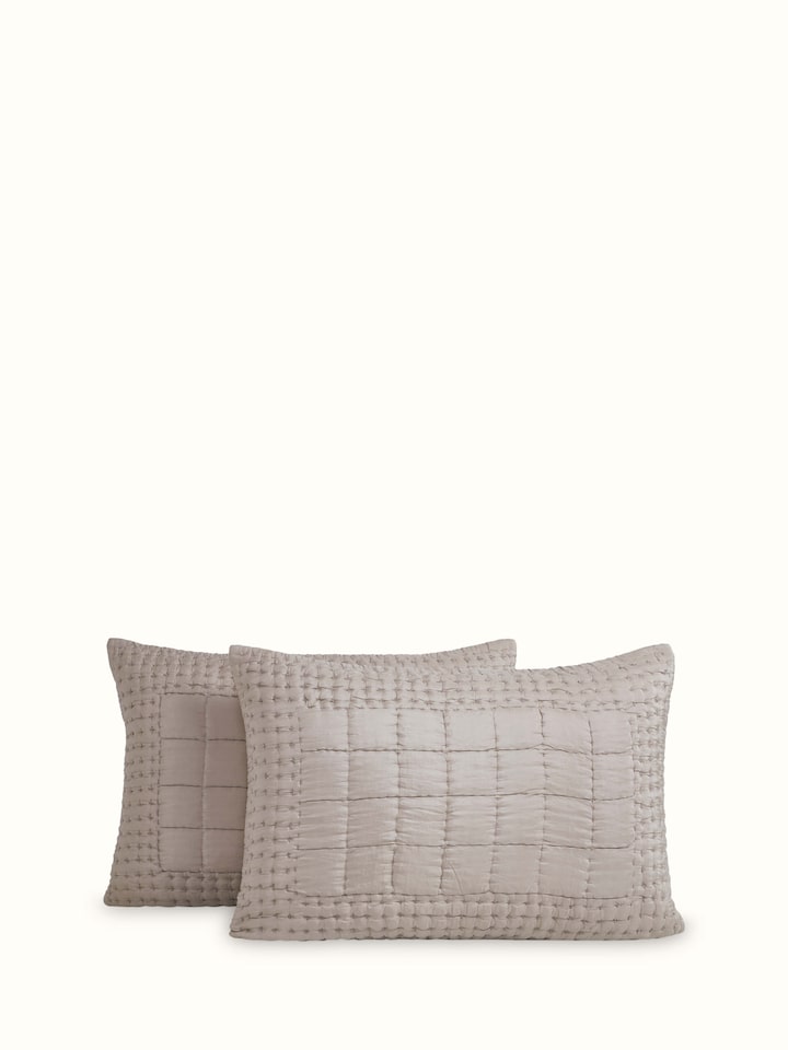 Pipa Grey Solid Silk Razai Bedspread Set laid out on a bed, highlighting the smooth silk texture and embroidered accents.