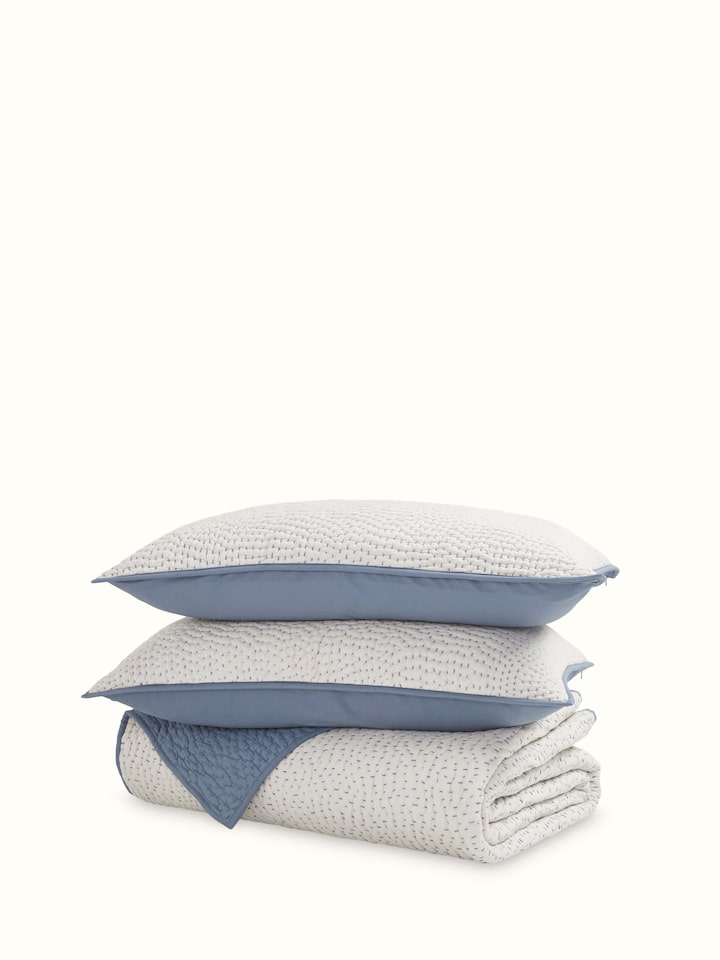 Front view of a beige two-tone textured cotton razai embroidered double bedspread set, highlighting the intricate embroidery and two-tone textured design.
