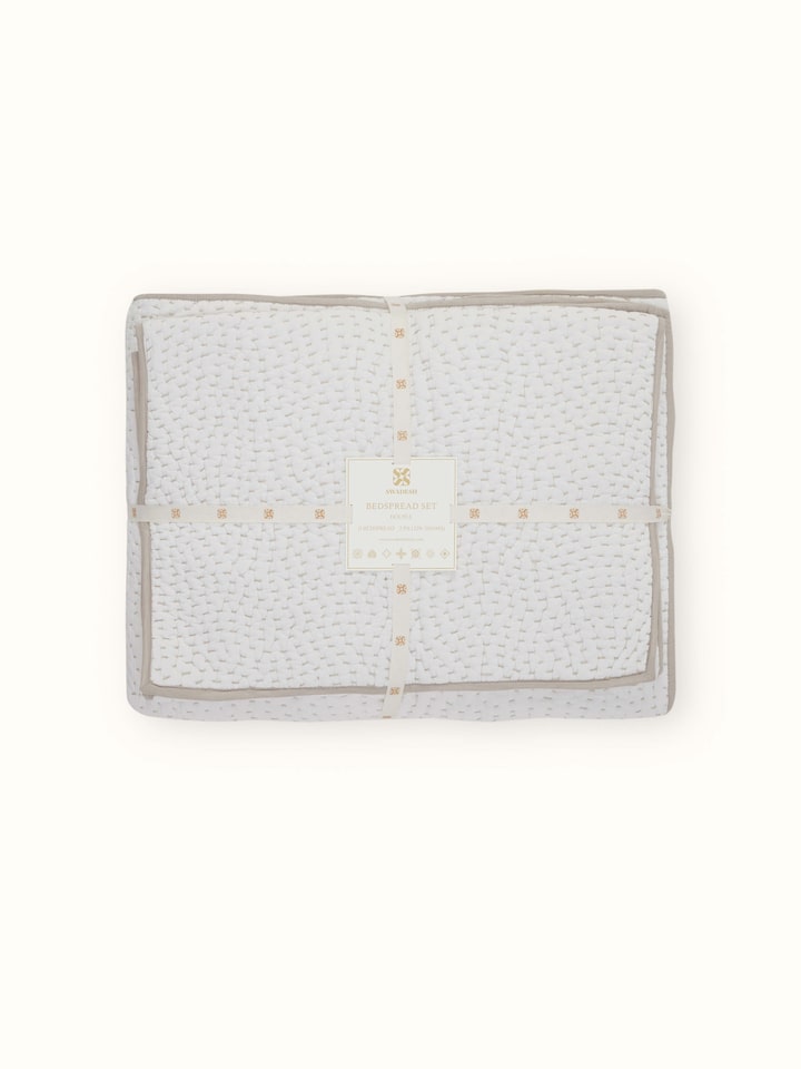Close-up of Nityam Ivory Two-Tone Textured Cotton Razai Embroidered Double Bedspread Set highlighting the fabric’s texture.