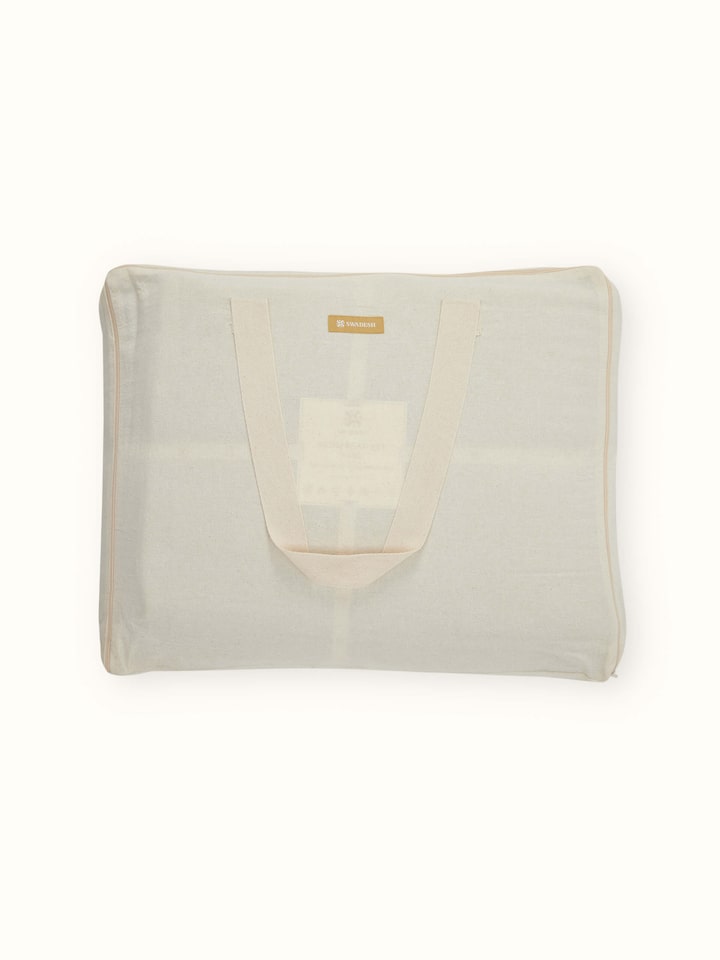 Close-up of Vaayu beige chambray textured cotton razai embroidered double bedspread set displaying its rich texture