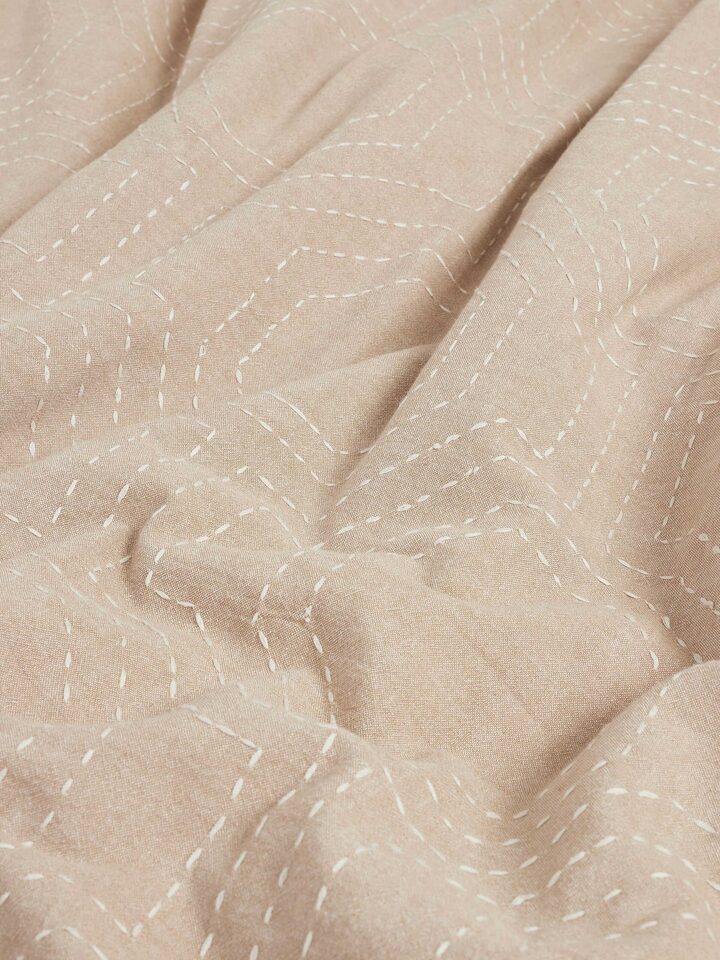 Kahani brown geometric cotton duvet cover arranged to show the Kantha embroidery design and fabric detail.