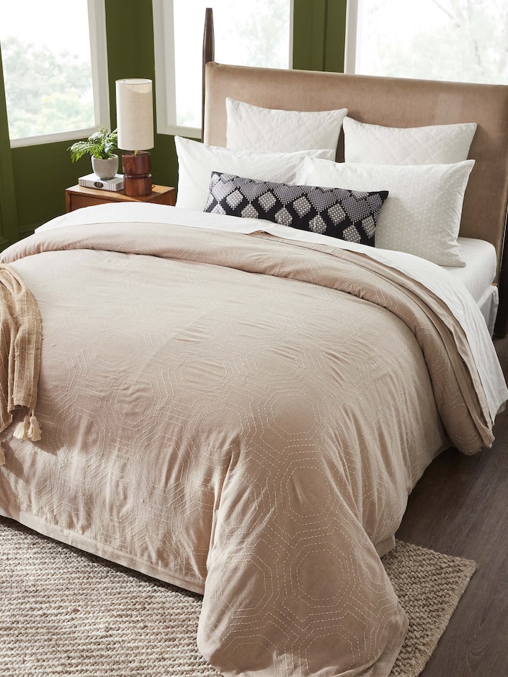Close-up of Kahani brown geometric cotton duvet cover showing detailed Kantha embroidery and geometric pattern.
