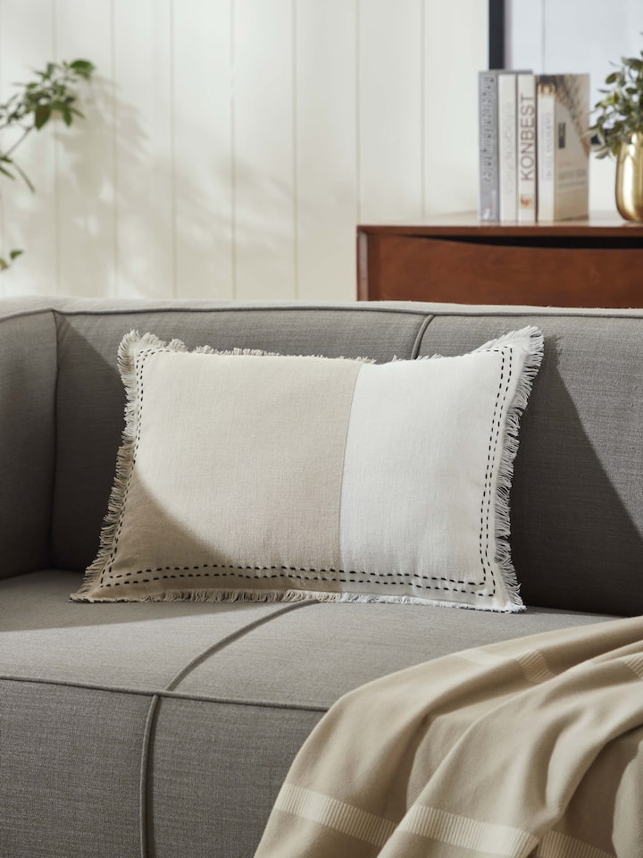 Side view of Kahani beige two tone linen kantha hand embroidery cushion cover highlighting the fabric's texture