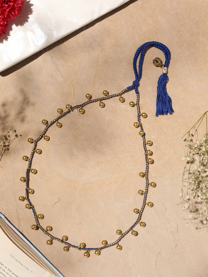 Side view of Dhokra Long Necklace showcasing the intricate metal details and design.