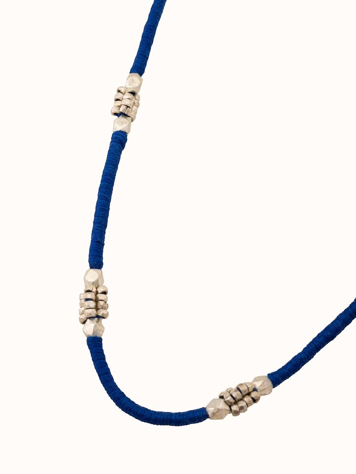 Angled view of Dhokra Long Necklace displaying the detailed Dhokra metalwork and design.