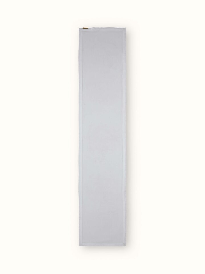Back view of white linen bed runner with smooth finish and subtle embroidery hints.