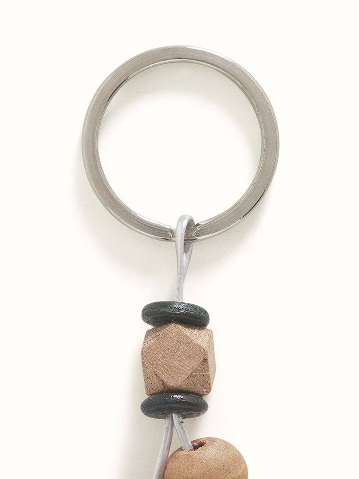 Side view of brown block-making wooden keychain, showing its shape and details.