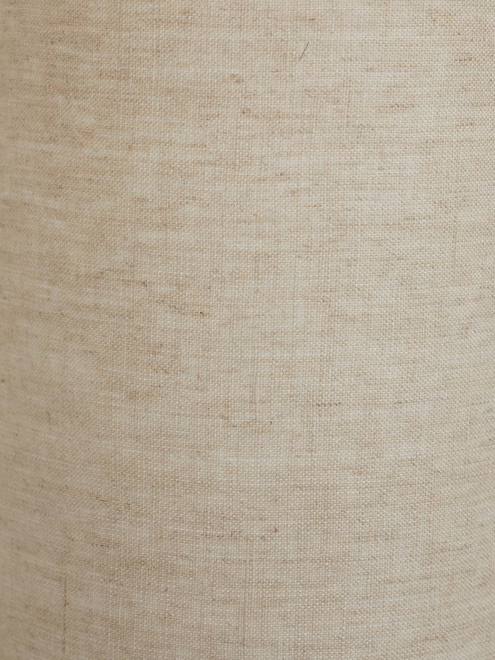 Full view of tall beige wood and cotton fabric table lamp, highlighting the lamp's elegant design and functionality.