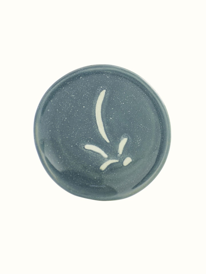 Side view of a grey studio pottery ceramic salad plate, emphasizing its minimalist design and contemporary style.