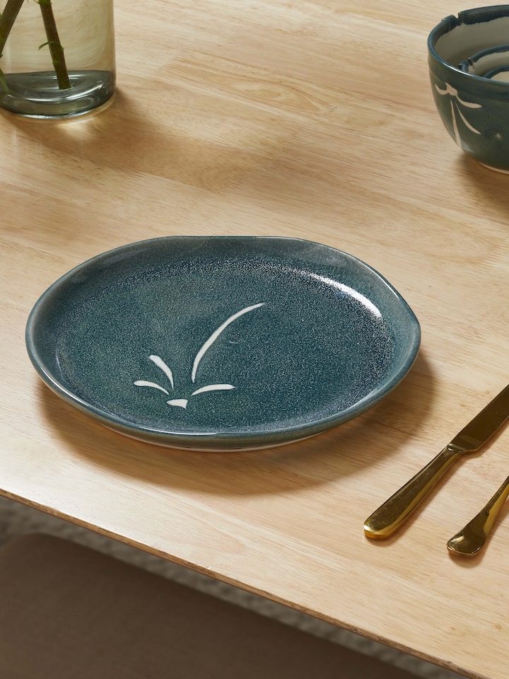Side view of Studio pottery ceramic dinner plate large highlighting its contemporary shape and clean glaze