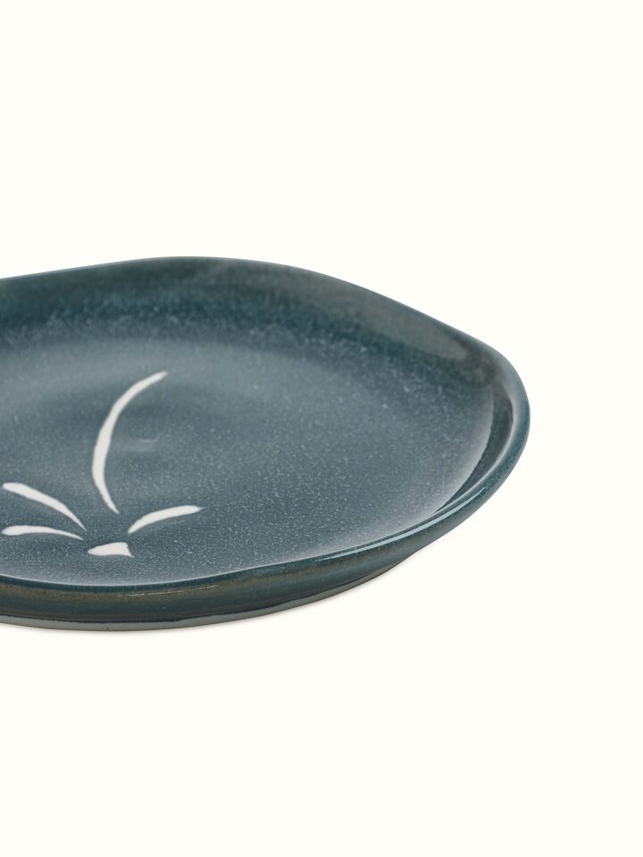 Close-up of Studio pottery ceramic dinner plate large focusing on the smooth texture and elegant design