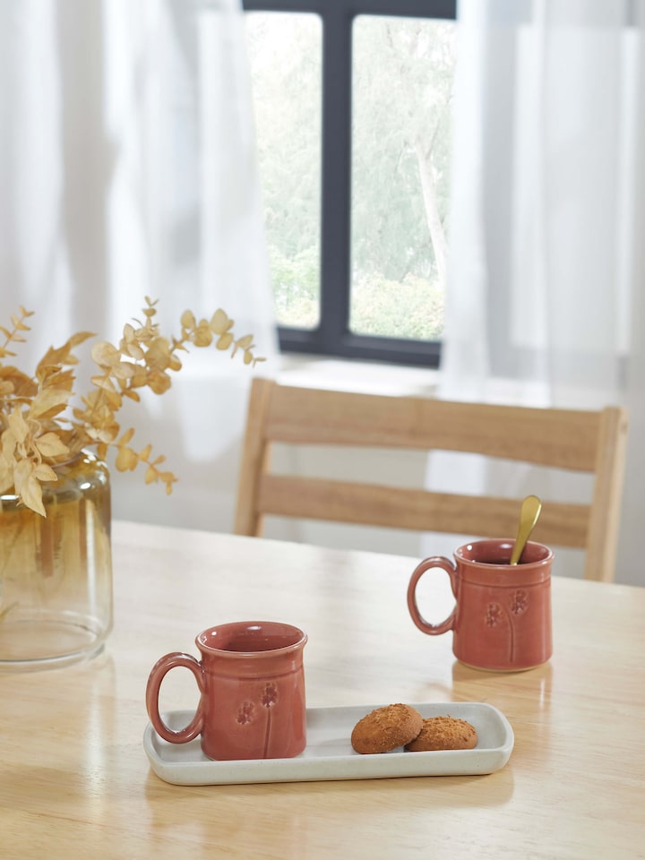 Side view of Studio pottery ceramic coffee mugs in various colors, set of 2, emphasizing the handcrafted design