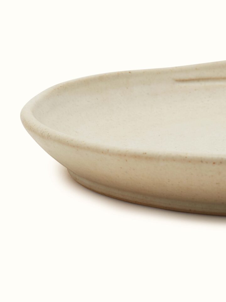 Side view of Studio Pottery Ceramic Dinner Plate Beige showing the depth and craftsmanship of the plate.