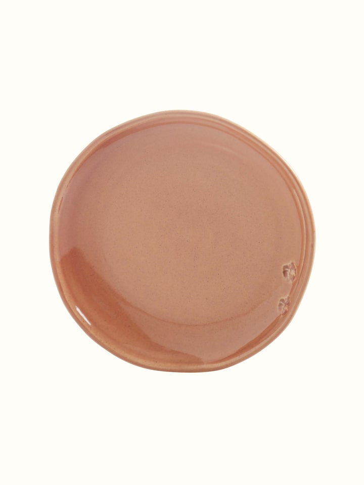 Angled view of studio pottery ceramic dessert plate in beige, emphasizing the delicate glaze and artisanal quality
