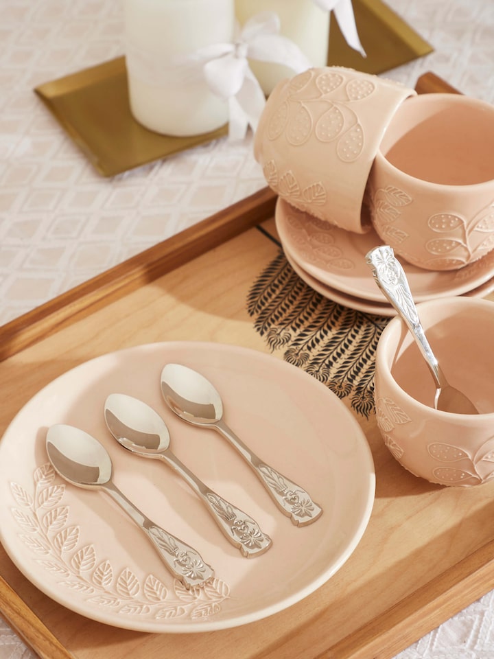 Front view of brass teaspoons, showcasing their classic shape and shiny surface.
