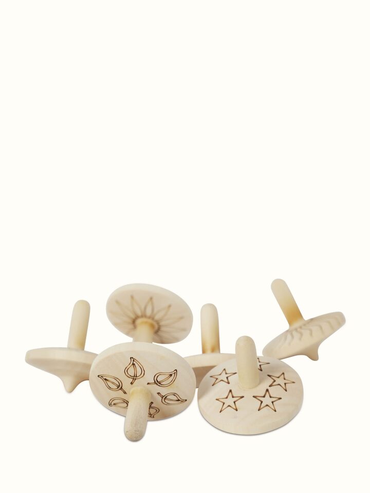 Front view of Channapatna Ivory Wood Spinning Top Toys in Off-White showcasing traditional craftsmanship.