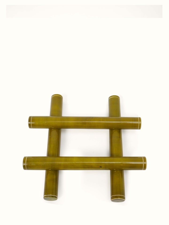 Side view of Channapatna ivory wood tic-tac game in green focusing on wooden finish.
