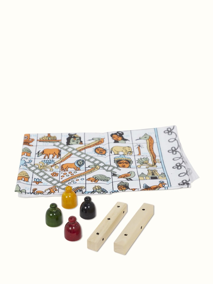 Angle view of Channapatna ivory wood snake and ladders board game in white