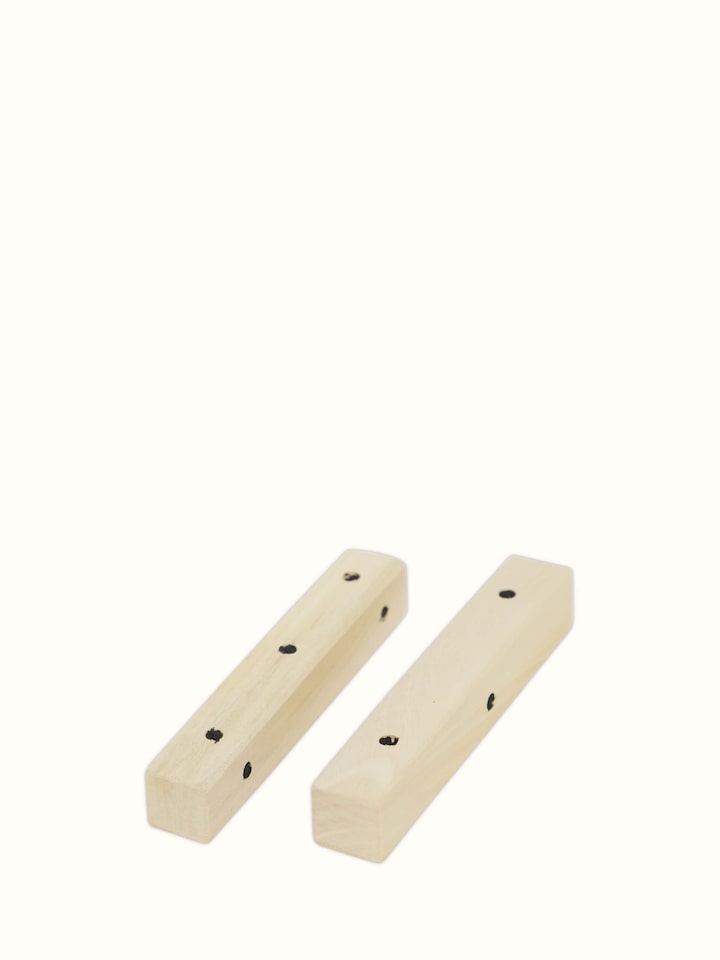 Detailed view of Channapatna ivory wood snake and ladders board game in white