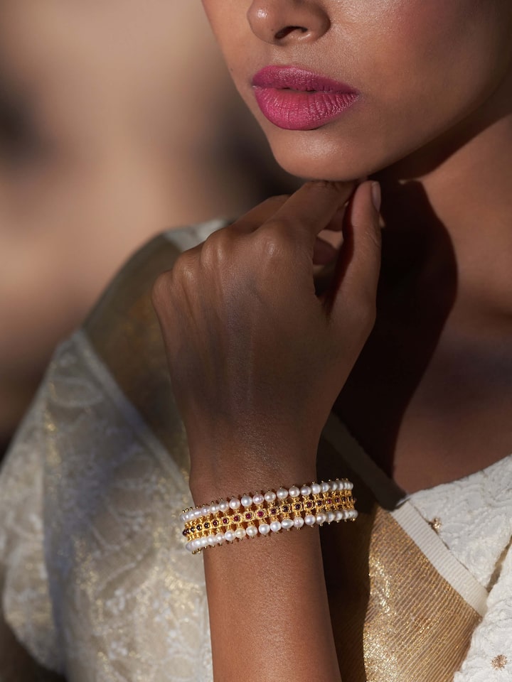 Side view of Guttapusalu silver bangle highlighting its detailed patterns and classic style