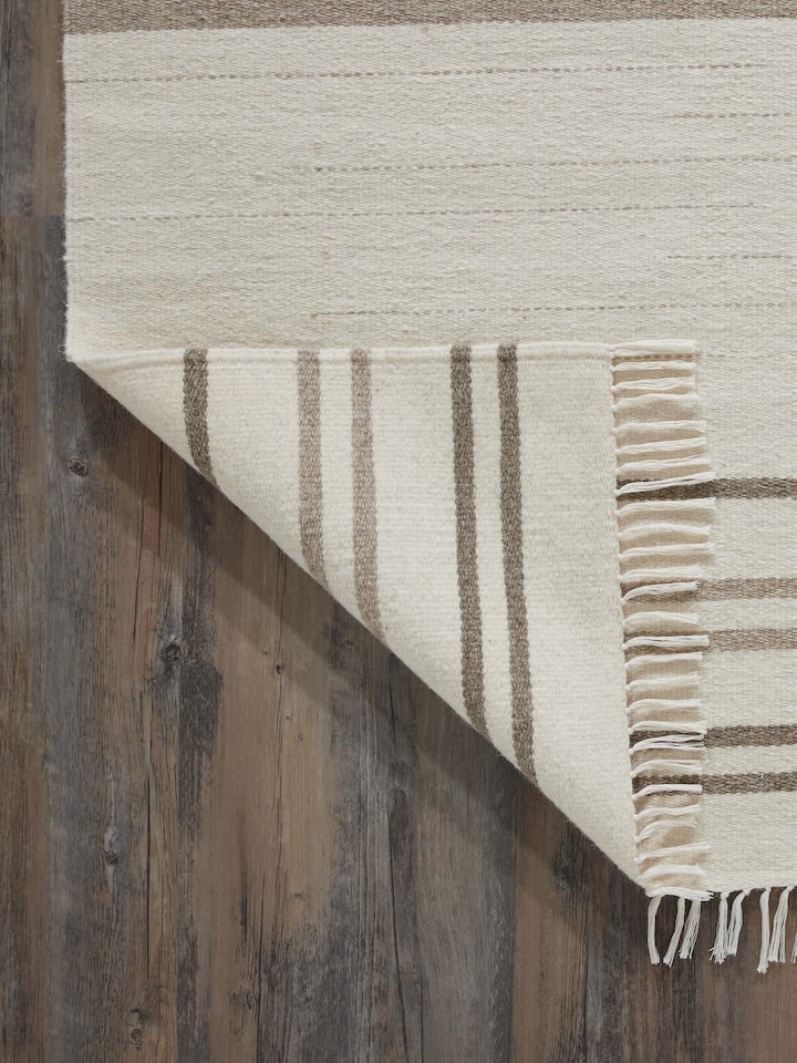 Close-up of Nomad Stripes Ivory Beige Jawaja wool & cotton handloom dhurrie focusing on the fabric texture and stripe design.