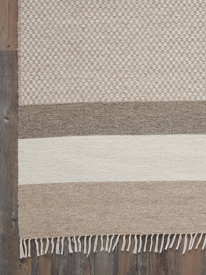 Perspective view of Geo checkered beige Jawaja wool & cotton handloom dhurrie (4x6 ft) showcasing the full pattern and texture.