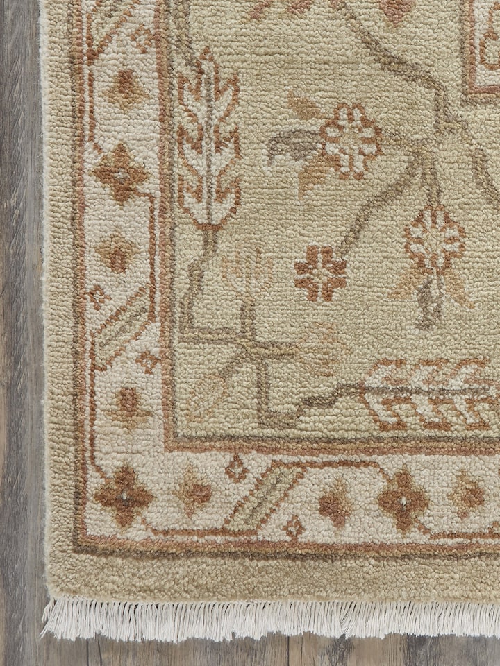 Angled view of Oushak Traditional Beige Brown Jaipur Wool Hand-Knotted Rug, emphasizing the rug’s design and texture.