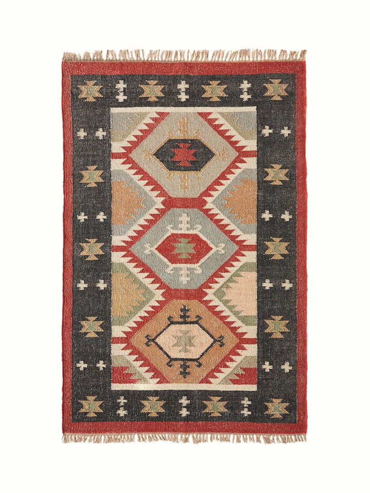 Full view of Traditional Kilim Black Lawan jute & wool panja dhurrie, featuring a black and earthy pattern.
