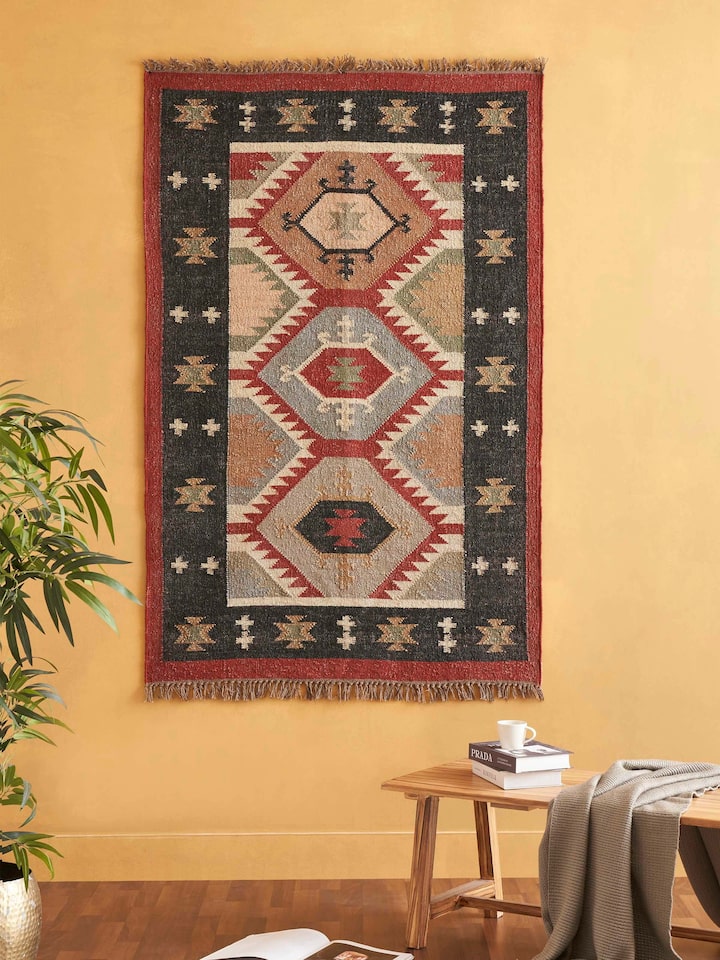 Close-up of Traditional Kilim Black Lawan jute & wool panja dhurrie, highlighting the intricate black pattern and fabric texture.