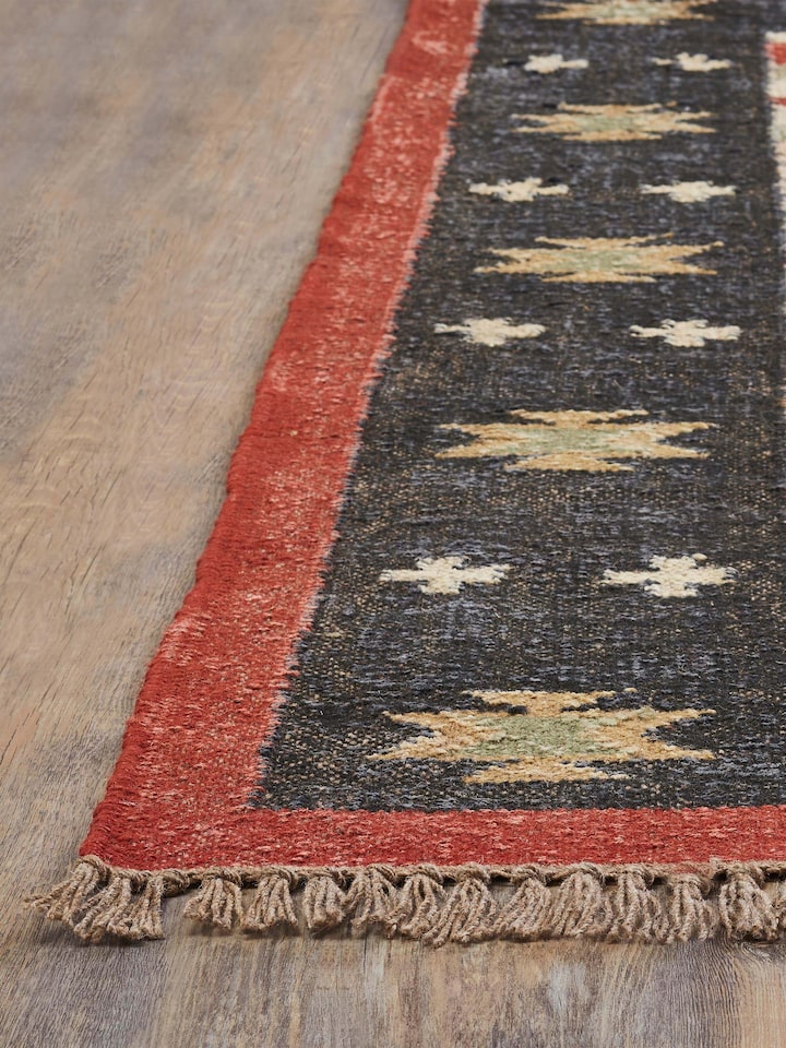 Detailed view of Traditional Kilim Black Lawan jute & wool panja dhurrie, emphasizing the kilim pattern and color contrast.