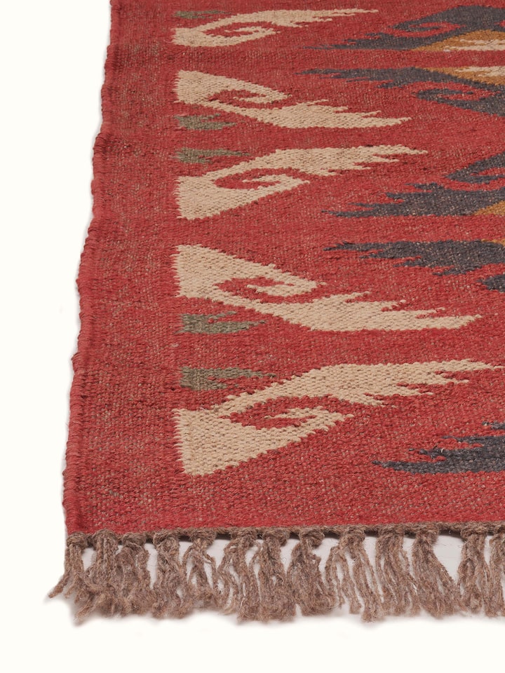 Detailed close-up of Traditional kilim red lawan wool & jute panja dhurrie showing the weaving pattern