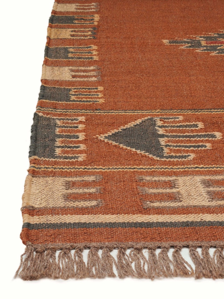 Close-up of Traditional Kilim rust lawan wool & jute panja dhurrie emphasizing the detailed kilim weaving and color variation