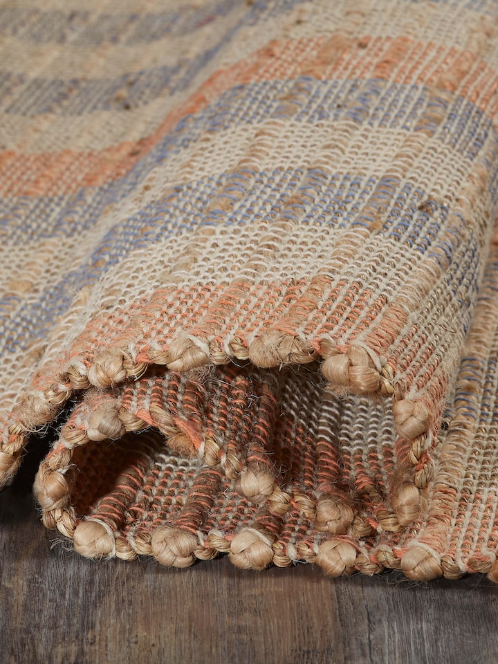Textured beige blue lawan jute & cotton natural fibre rug shown in a setting, emphasizing its design and texture.