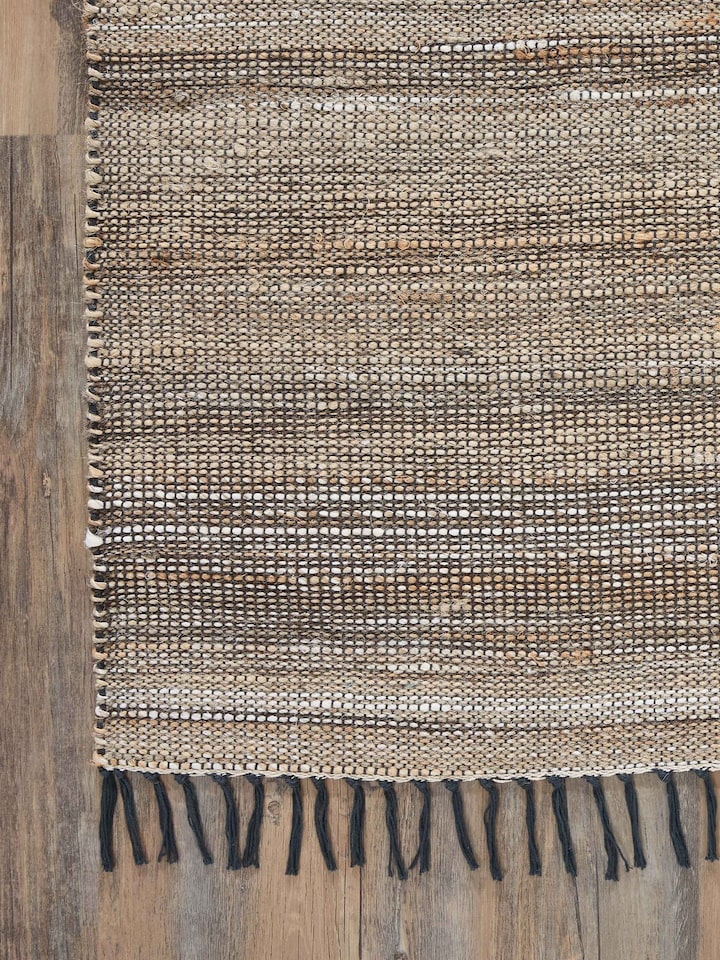 Side view of Textured Beige Charcoal Lawan Jute & Cotton Natural Fibre Rug, showing the depth and texture of the fibers.