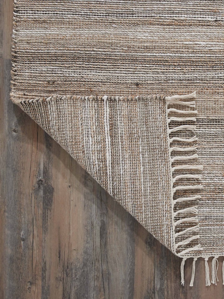 Full view of Textured Beige Black Lawan Jute & Cotton Rug on the floor, demonstrating its practical use and aesthetic appeal.