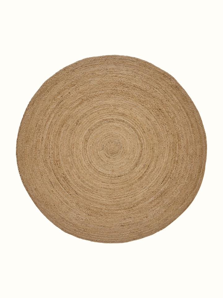 Braided round beige jute natural fibre rug, highlighting its texture and circular design.