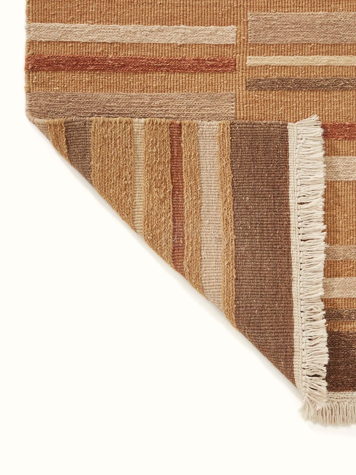 Detailed view of Geo solid textured sumak rust Bhadohi wool hand-knotted rug highlighting the texture and craftsmanship.