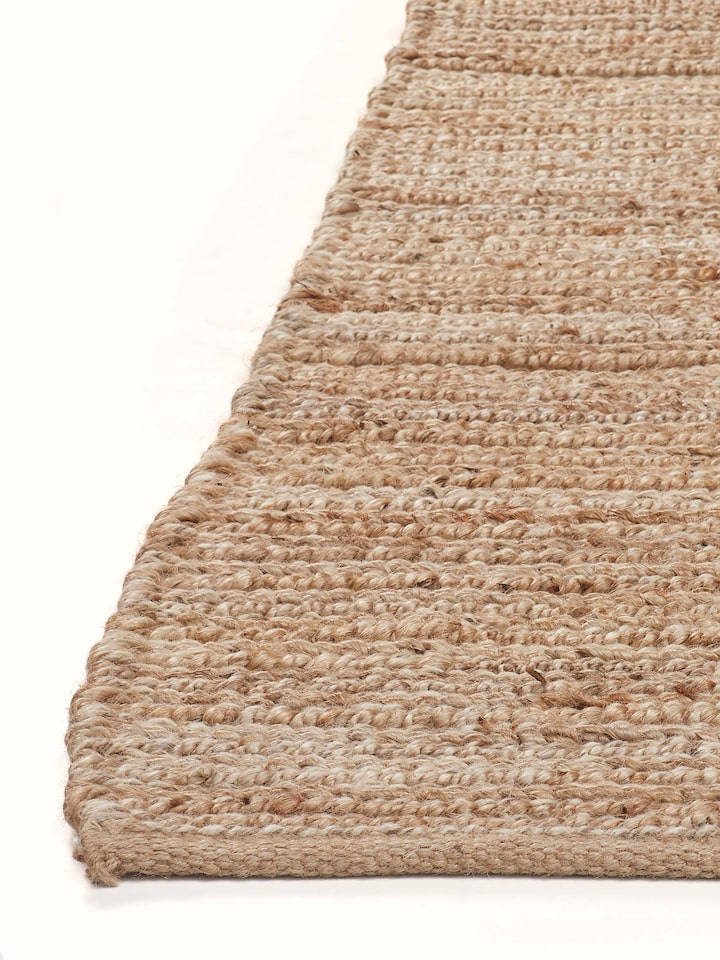Side view of textured solid beige jute & wool natural fibre rug (5x8 ft) capturing the depth and texture of the rug.