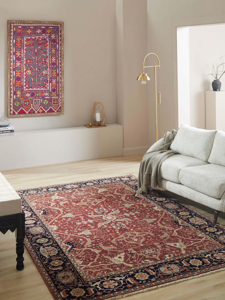 Close-up of Traditional Heriz red Bhadohi wool hand-knotted rug, highlighting the detailed design and texture.