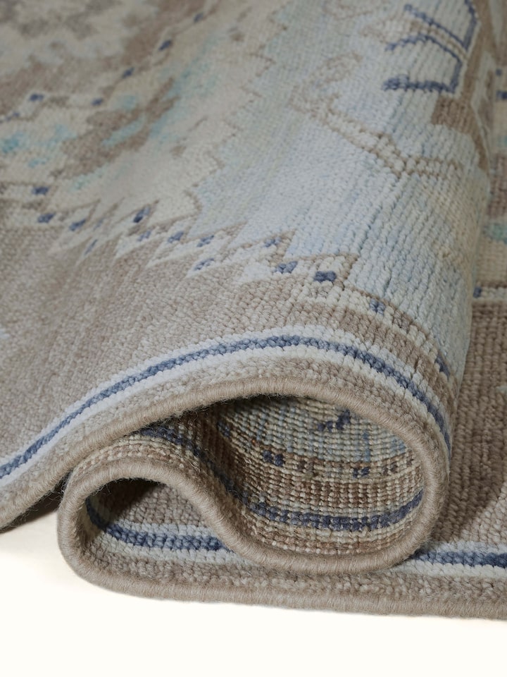 Traditional Oushak Grey Blue Bhadohi Wool Hand-Knotted Rug, displayed in a room to show its size and placement.