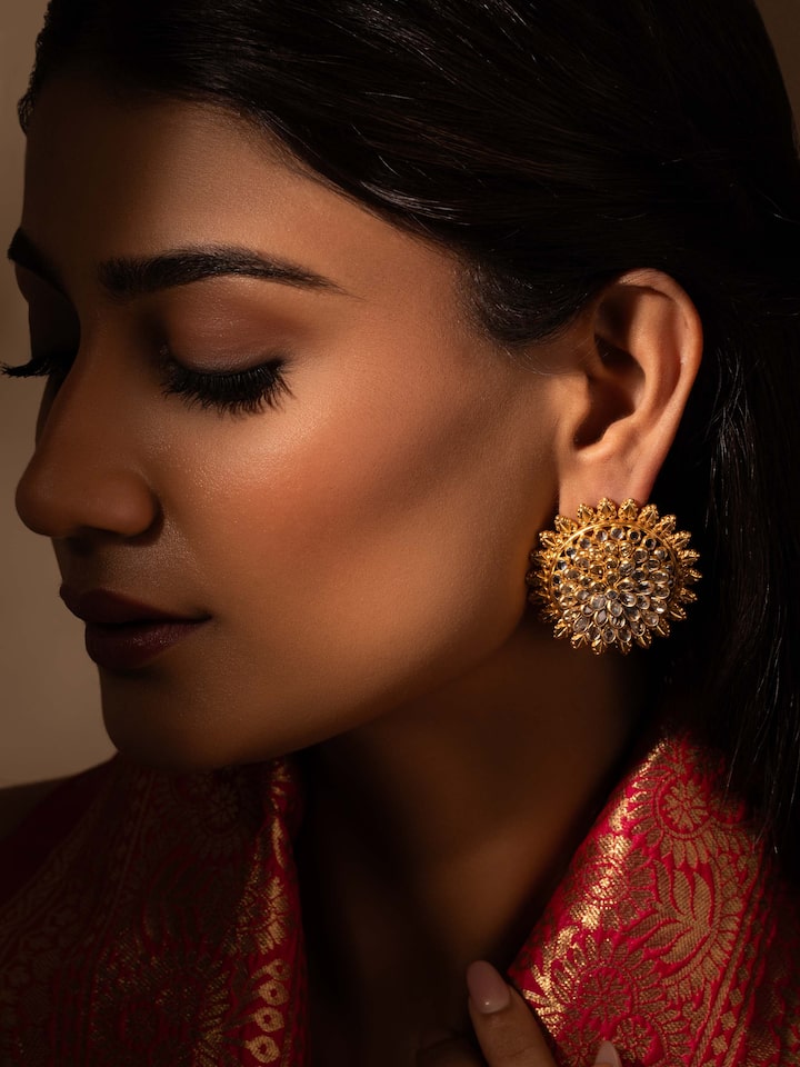 Side view of silver smithing stud earrings displaying their elegant shape and subtle design details